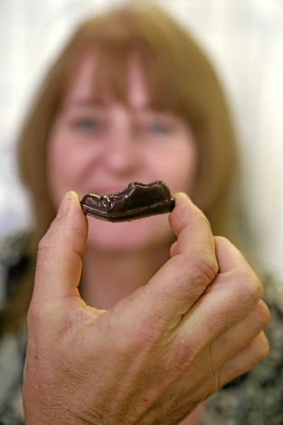 Эксперт по шоколаду Блэ Пуйе (Blaise Poyet) показывает журналистке сделанные из шоколада туфли Чарли Чаплина